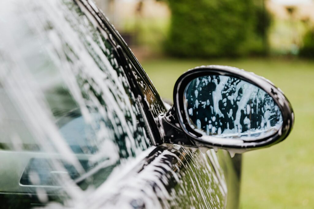 A car being washed by a trustworthy mobile detailing company found on MobileDetailingBiz directory