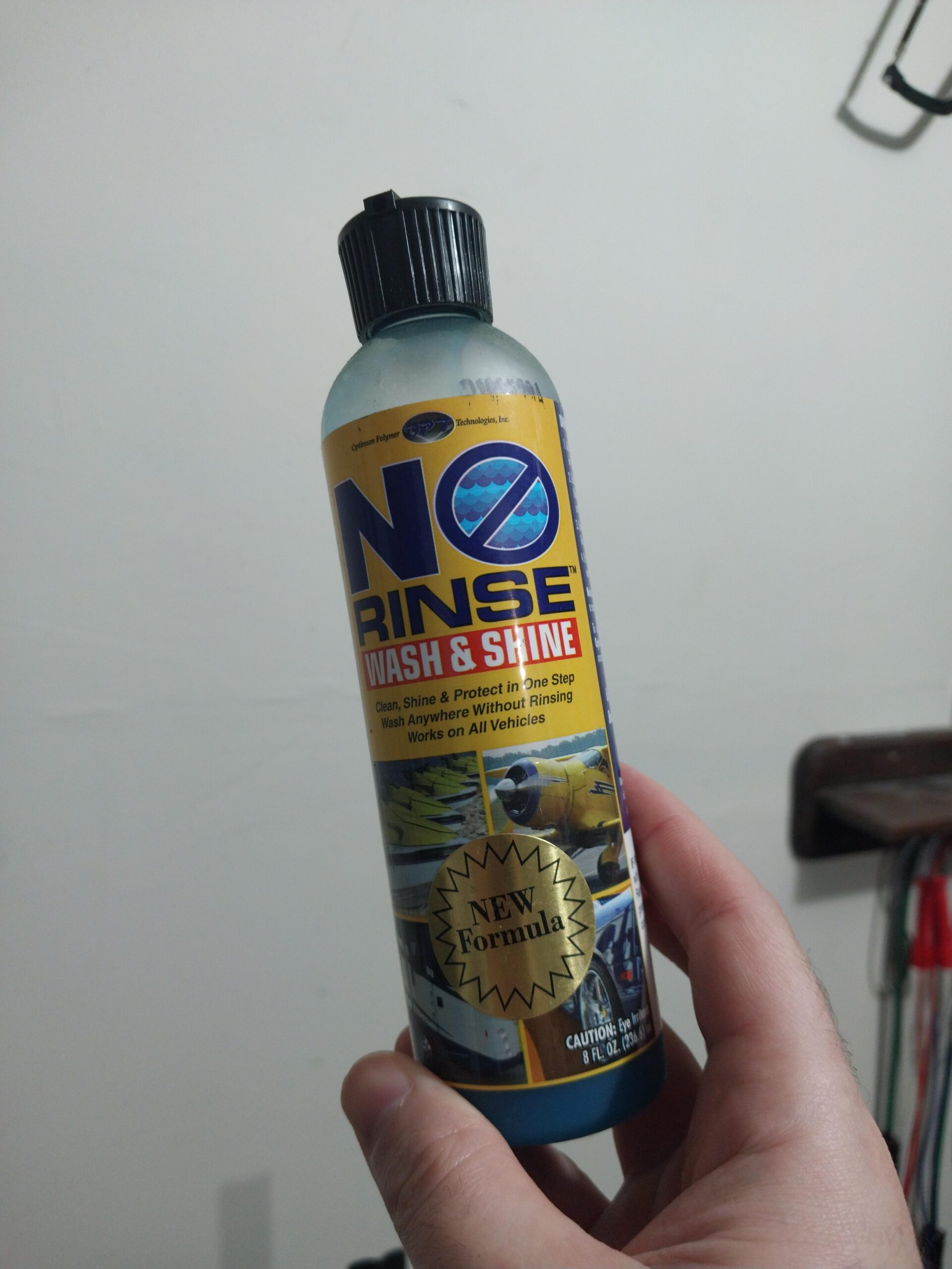 a mobile detailer holding up a used bottle of ONR